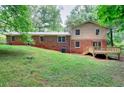 Back of the house features a deck and sprawling lawn, perfect for relaxation and entertainment at 2802 Leisure Woods Ln, Decatur, GA 30034