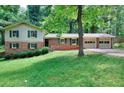 Traditional two-story home with attached garage, featuring a well-manicured front lawn at 2802 Leisure Woods Ln, Decatur, GA 30034