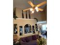 Bright living room with a high ceiling, ceiling fan, and decorative accents above an archway at 413 W Wind Dr, Villa Rica, GA 30180