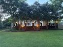Inviting backyard with string lights, a brick paver staircase, and lush landscaping for outdoor entertaining at 881 Park Manor Nw Ct, Marietta, GA 30064