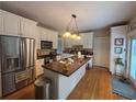 Bright kitchen with stainless steel appliances, a center island with countertop seating, and ample white cabinetry at 881 Park Manor Nw Ct, Marietta, GA 30064