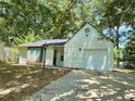 Charming one-story home with light siding, dark roof, attached garage, and a well-manicured front yard at 850 Greenhedge Dr, Stone Mountain, GA 30088