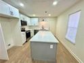 Modern kitchen featuring white cabinets, quartz countertops, stainless steel appliances and large island at 850 Greenhedge Dr, Stone Mountain, GA 30088