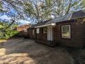Rear exterior view of the brick home with a small porch and access to the backyard at 2904 Glenwood Se Ave, Atlanta, GA 30317