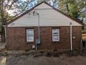 Exterior side view of brick home with windows and utility connections visible at 2904 Glenwood Se Ave, Atlanta, GA 30317