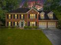 Charming two-story brick home featuring manicured lawn and attached two-car garage at twilight at 4961 Thornwood Nw Trce, Acworth, GA 30102