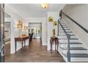 Inviting foyer featuring hardwood floors, staircase with painted trim and decorative accents at 4961 Thornwood Nw Trce, Acworth, GA 30102