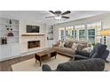 Bright living room with fireplace, built-in bookshelves, and large windows at 4961 Thornwood Nw Trce, Acworth, GA 30102