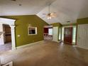 Open-concept living room showing high ceilings, views to the kitchen, and access to other rooms in the house at 1855 Tribble Ridge Dr, Lawrenceville, GA 30045