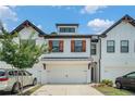 Delightful townhome showcases a convenient two-car garage, accented by wood shutters, creating an inviting curb appeal at 211 N Auburn Landing Pl, Auburn, GA 30011