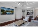 Bright living room with a large screen TV, modern decor, and hardwood floors, creating a comfortable space at 325 E Paces Ferry Ne Rd # 1910, Atlanta, GA 30305