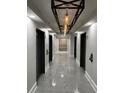 Hallway featuring modern lighting fixtures and stylish tile flooring at 1280 W Peachtree Nw St # 4003, Atlanta, GA 30309