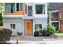Close up of the home's entryway featuring an orange front door and well-maintained landscaping at 1463 Macklone Ne St, Atlanta, GA 30307