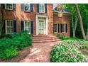 Inviting brick pathway and steps lead to the home's entrance, surrounded by lush landscaping at 1781 Point Pleasant Se, Smyrna, GA 30080