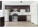 Kitchen features stainless steel appliances, dark cabinets and subway tile backsplash at 2879 Harlan Dr, Atlanta, GA 30344