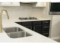 Modern kitchen features a stainless steel sink, a gas stove, and lovely stone countertops at 623 Shadowmoore Dr, Riverdale, GA 30274