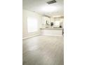 Bright living space connected to kitchen, featuring modern flooring and ample natural light at 623 Shadowmoore Dr, Riverdale, GA 30274