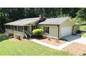 Well-maintained single-story home with an attached garage and a manicured lawn at 180 Bishop Nw Rd, Cartersville, GA 30121