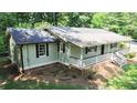 Well-maintained single-story home featuring a covered front porch, rear deck, and mature landscaping at 180 Bishop Nw Rd, Cartersville, GA 30121