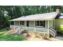 Charming single-story home featuring an inviting front porch with brick accents at 180 Bishop Nw Rd, Cartersville, GA 30121
