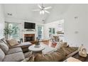Spacious living room featuring a fireplace and open layout to dining area at 2140 Hurt Sw Rd, Marietta, GA 30008