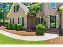 Close-up of a lovely brick home with a welcoming entrance and trimmed landscaping at 2832 Windrush Dr, Buford, GA 30518