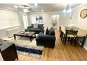 Cozy living room with modern furnishings and decor, featuring a ceiling fan and wooden flooring at 300 Peachtree Ne St # 11I, Atlanta, GA 30308