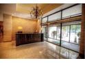 Building lobby featuring a dark wood reception desk, marble flooring, and glass entrance at 300 Peachtree Ne St # 11I, Atlanta, GA 30308