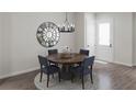 Cozy dining area featuring a round wooden table, stylish chairs, and modern chandelier at 947 Willingham Dr # 2, Hapeville, GA 30354
