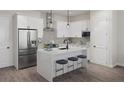 Modern kitchen with white cabinets, stainless steel appliances, quartz countertops, and stylish stools at 947 Willingham Dr # 2, Hapeville, GA 30354