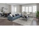 Bright living room with contemporary furnishings, including a blue sofa, chairs, and a coffee table at 947 Willingham Dr # 2, Hapeville, GA 30354