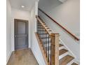 Staircase features wood steps, black metal spindles, and a matching handrail at 1273 Harvest Park Ln, Suwanee, GA 30024