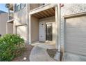 Townhome entrance with a brick facade, covered entry, and single car garage at 1843 Broad River Rd, Atlanta, GA 30349