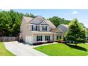 Traditional two-story home with lush front lawn, driveway, and inviting curb appeal at 405 Blue Sky Circle Cir, Acworth, GA 30102