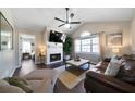 Cozy living room features hardwood floors, a fireplace, ceiling fan, and large window for natural light at 4312 Daniel Dr, Winston, GA 30187