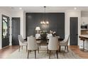 Elegant dining room with seating for six, complemented by a modern chandelier and wainscoting wall at 945 Willingham Dr # 3, Hapeville, GA 30354