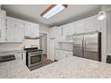 Modern kitchen with white cabinets, granite countertops, stainless steel appliances and recessed lighting at 1252 Grist Mill Dr, Acworth, GA 30101