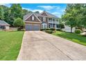 Spacious two-story home with brick facade, two-car garage, and a long driveway at 6236 Millstone Trl, Douglasville, GA 30135
