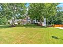 Exterior view of a two-story home with brick and siding, a large front yard, and mature trees at 6236 Millstone Trl, Douglasville, GA 30135