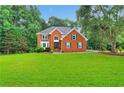 Beautiful red brick two-story home with an expansive green lawn at 2071 Habersham Cir, Covington, GA 30014