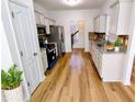 Bright kitchen featuring stainless steel appliances, white cabinets, hardwood floors and granite countertops at 5050 Roxton Ln, Douglasville, GA 30135