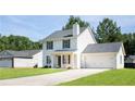 Well-maintained two-story home with a two-car garage and a long driveway offers classic suburban charm at 5484 Denny Dr, Atlanta, GA 30349