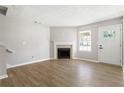 Inviting living room with a fireplace, light gray walls, and wood flooring creates a modern and comfortable atmosphere at 5484 Denny Dr, Atlanta, GA 30349