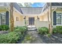 Inviting front entrance with an iron gate, brick accents, manicured greenery, and address displayed at 522 Golfview Dr, Peachtree City, GA 30269