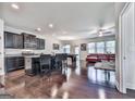 Open concept living space with dark wood floors and accents, stainless steel appliances, and comfortable seating at 5512 Cascade Run, Atlanta, GA 30336