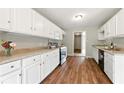 Well-maintained kitchen with white cabinets, granite countertops, and modern stainless steel appliances at 75 Fox Chase, Covington, GA 30016