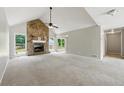 Spacious living room boasting high ceilings, stone fireplace, and sliding glass doors to the back deck at 75 Fox Chase, Covington, GA 30016