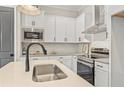 Bright and modern kitchen featuring white cabinets, stainless steel appliances, and an island sink at 937 Willingham Dr # 7, Hapeville, GA 30354