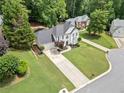 Beautiful home on a large, well-maintained lot with mature trees and lush landscaping at 2019 Aldbury Ln, Woodstock, GA 30189