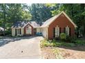Charming single-story home with a brick facade and a well-manicured front yard at 2030 Buford Dam Rd, Buford, GA 30518
